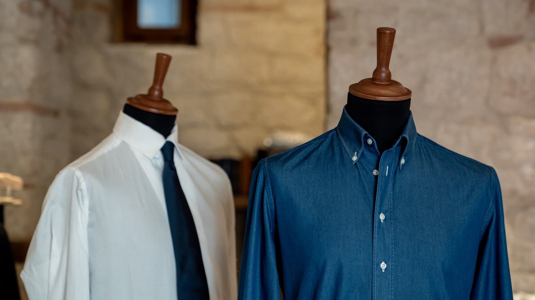 Garments on tailoring forms inside an Italian manufacturing atelier