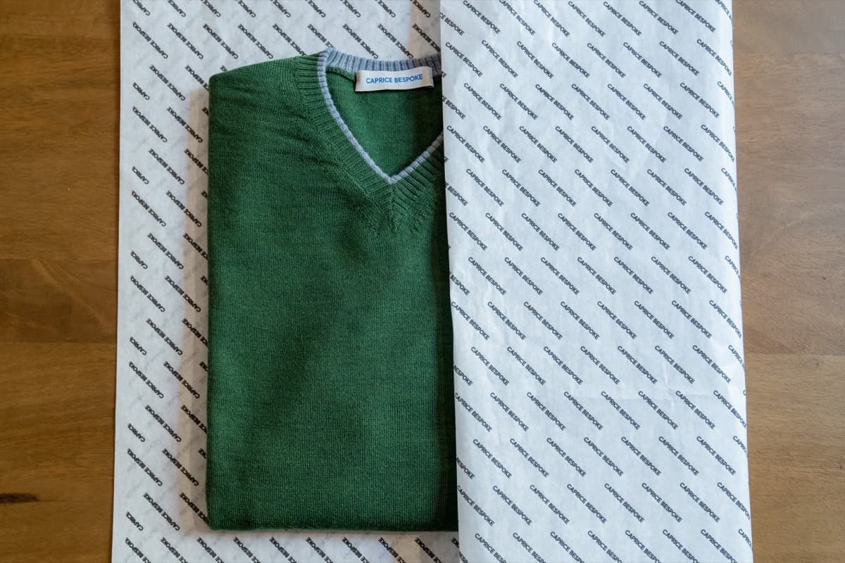 A green fine-gauge V-neck knit produced in Italy under a partner brand label