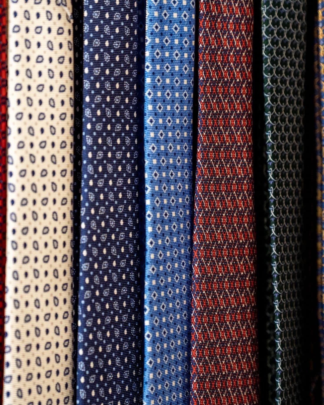A close row of patterned silk neckties woven from Italian mill cloth